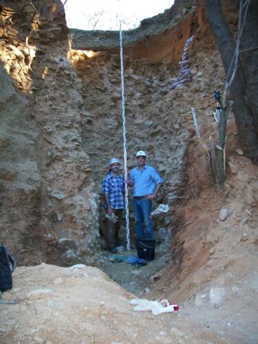 The ancient alluvial gravels which are packed full of stone tools also contain small amounts of diamonds. Here archaeologists stand in front of a sequence that dates from 1.7 million years ago near the bottom to 1.2 million years at the top. The red sands capping the gravels contain important later stone age artifacts as well. Photo shows Ryan Gibbon (left) and the author.