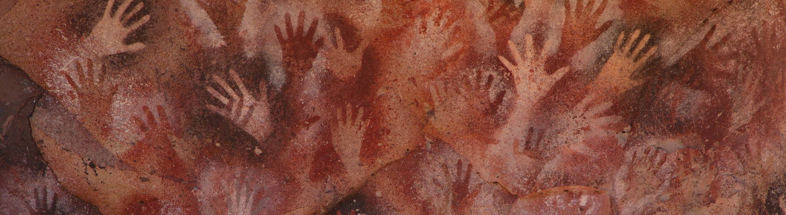 cave art handprints suggesting human creativity, contact, and connections