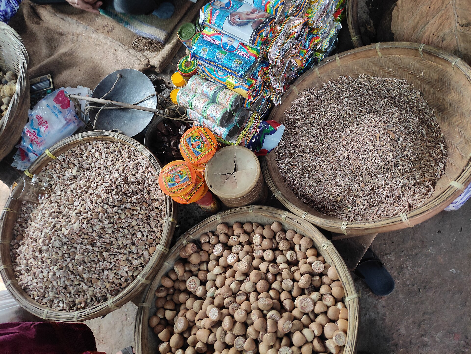 whole and sliced betel nut in bowls with other betel nut chewing components